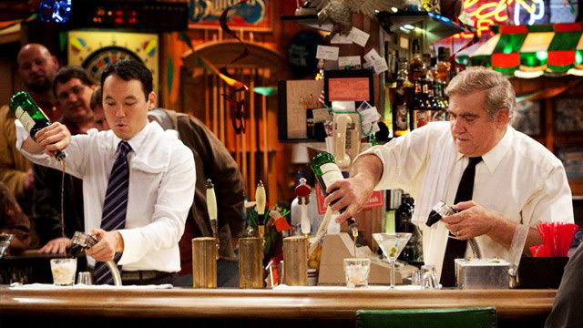 Sullivan & Son pouring shots behind the bar