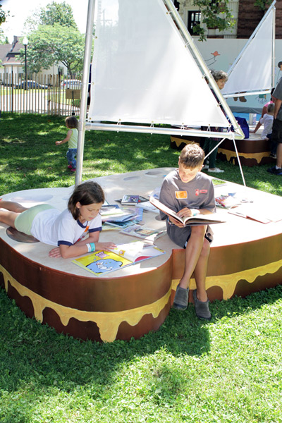 Children reading on a sandwich sailboat at Literary Lots in Cleveland