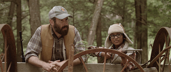 Butch and Smith on a log hunting in the forest