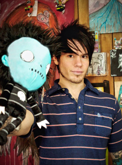 Joshua Jey Fields portrait with a doll of his creation